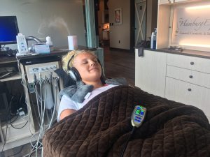 patient in chair at Hamburg Expressions- enjoying the spa amenities